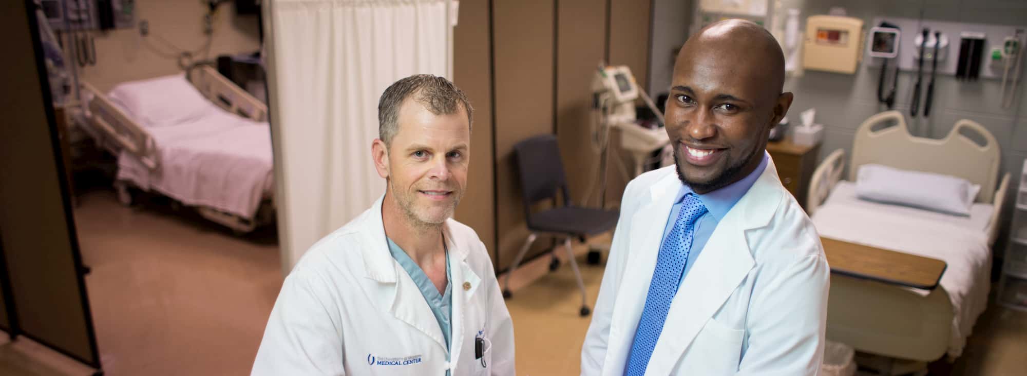 Two men standing in a clinical setting